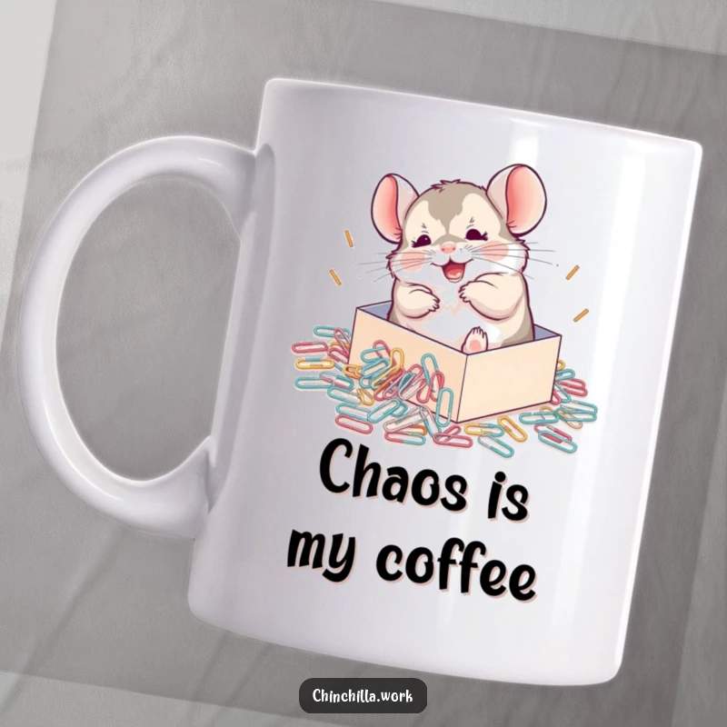 Funny Chinchilla Mug depicting a joyful chinchilla rolling around gleefully in a spilled box of shiny paperclips, a hilarious office gift.