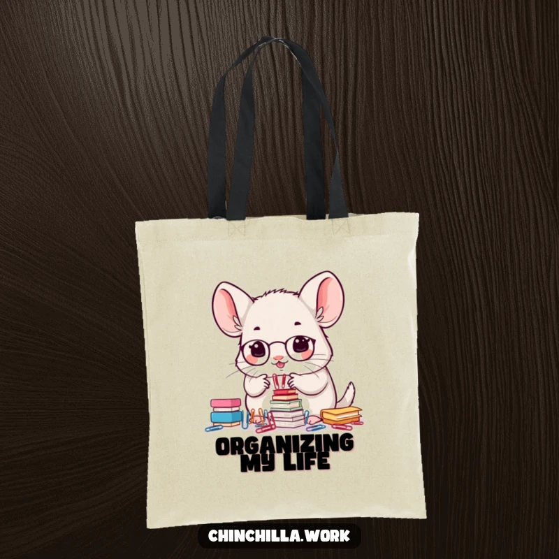 Funny tote bag featuring a kawaii office chinchilla precisely stacking small paperclips, highlighting organizational skills.